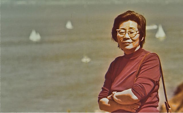 Jennifer Li Schotz's grandma posing next to the Mississippi Delta in a brown turtleneck