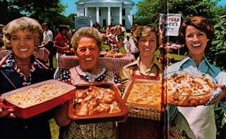 A newspaper with four women holding different kinds of dishes