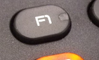 A close-up of an F1 key on the keyboard.