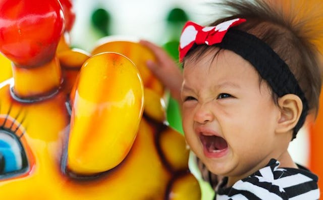 Kid crying in an amusement park