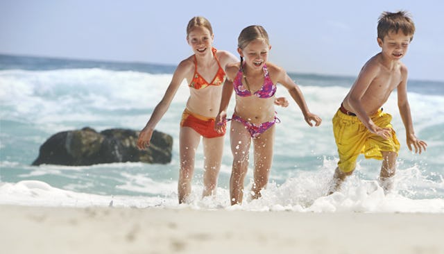 Three kids having fun on the beach 