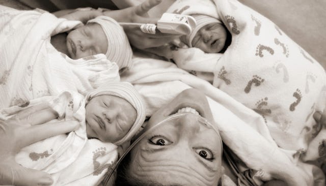 A woman with her newborn triplets