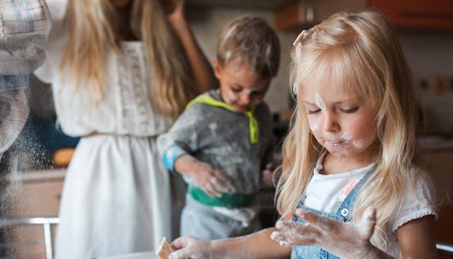 Brother and sister in the kitchen dusted with flour
