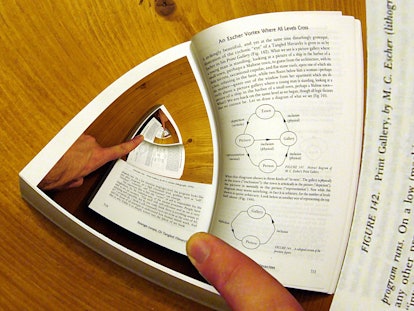 A distorted picture of a book's page that looks like it's turning into a never-ending loop