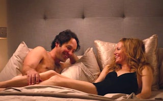 Paul Rudd and Leslie Mann in a scene from This is 40, laying in bed and laughing