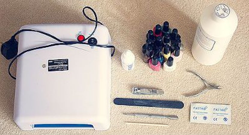 A manicure kit including a UV lamp, nail polish bottles, creams and other tools