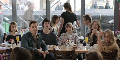 Cast from the "Girls" TV series sitting at a table 