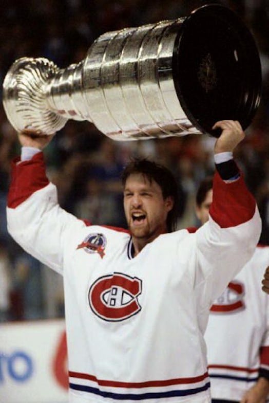 A Player Of The Habs Holding The Trophy In The Air After Canadiens Won The Stanley Cup