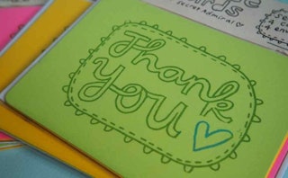 A lime green thank you note in cursive font as a part of a gift