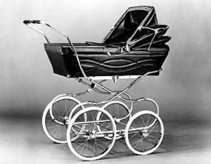 A blurred black-white photo of an old baby cart