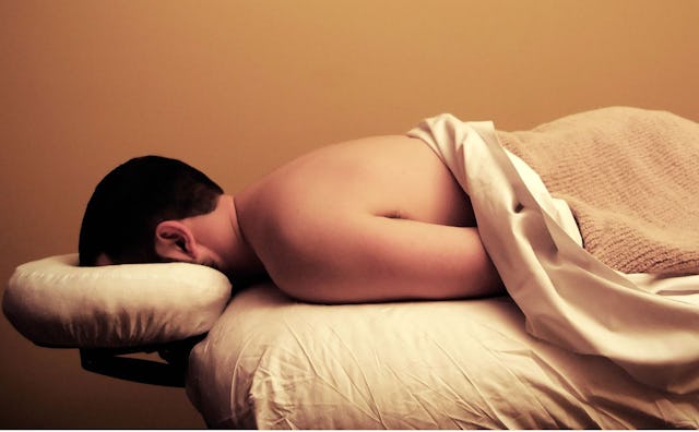 Man lying face down on a massage table