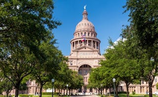 A view of a park in Austin with some historical buildings.