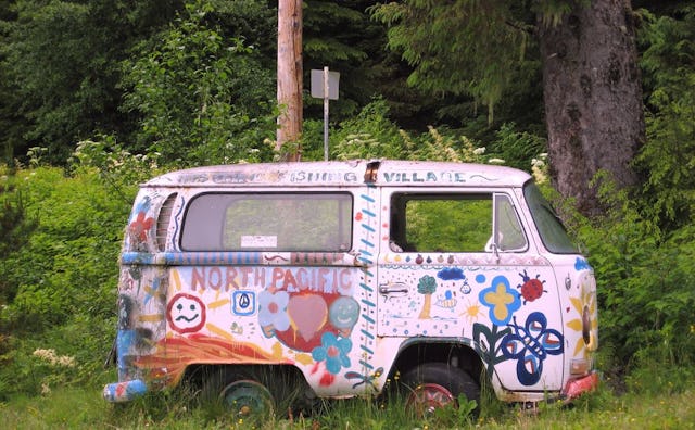 An old camper with a lot of drawings on it.