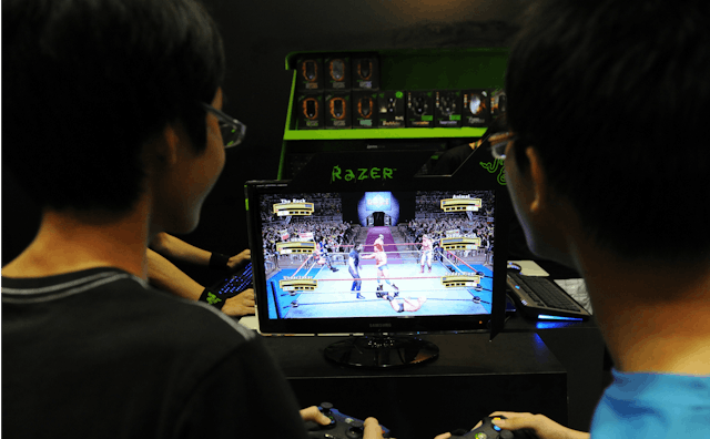 Two teens playing video games