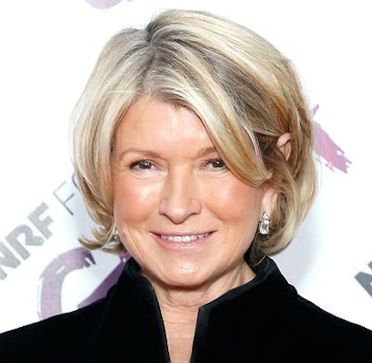 Martha Stewart with blonde hair smiling while wearing a black shirt