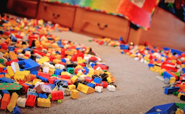 A gray floor with large stacks of building blocks and a clean path in the middle.