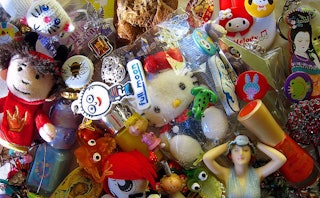 A pile of toys in various shapes, sizes, and colors in a messy room