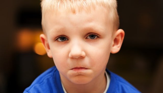 A Blond Boy Frowning 