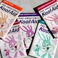 Five Kool-Aid packages of different flavors displayed on the ground