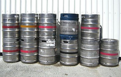 Eleven grey beer kegs
