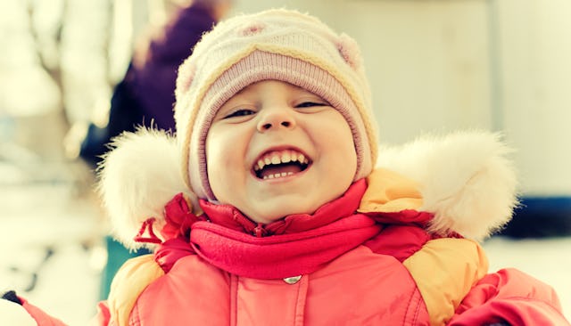 A kid in a winter outfit smiling
