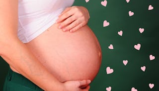 A mother holding her pregnant belly