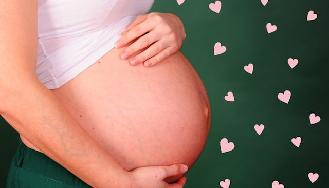 A mother holding her pregnant belly