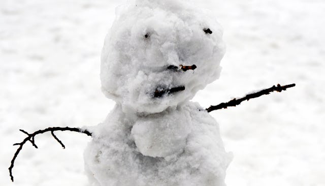 A snowman slowly melting away representing spring