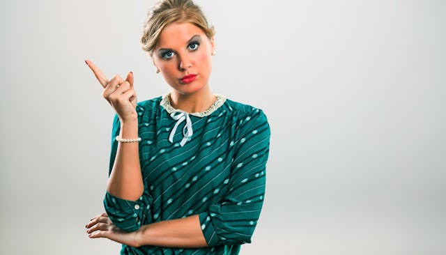 A blonde woman with a judging facial expression and one finger in the air scolding a mom in the Face...