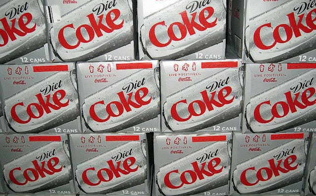 A stack of Diet Coke card boxes as a symbol of diet coke addiction