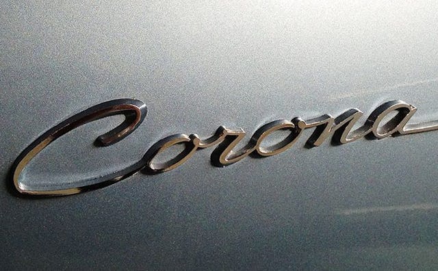 Toyota Corona logo on a silver car