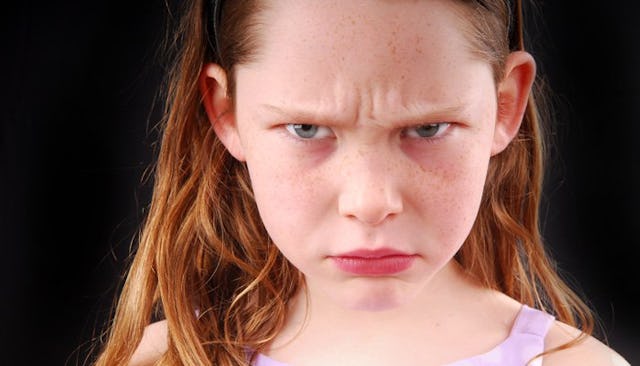 Angry kid looking at the camera.
