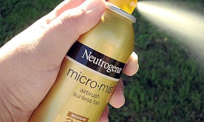 A  person spraying the Micro-mist Airbrush Sunless Tan by Neutrogena