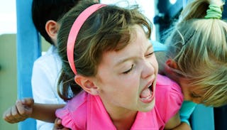 Little Girl Struggling To Get Out Of A Hug From Another Little Girl