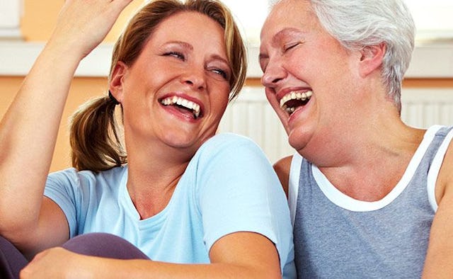 Two female friends laughing and enjoying their 40s