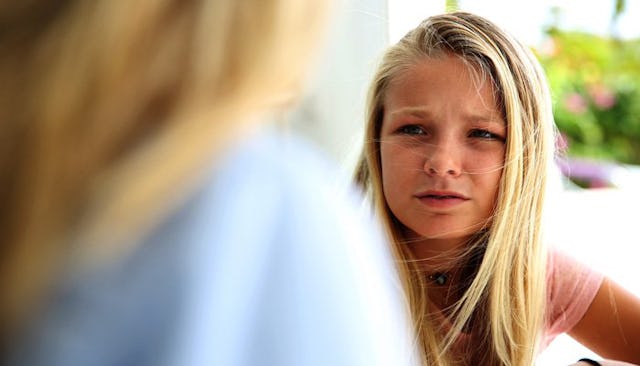A blonde girl looking angry at her widowed mother.