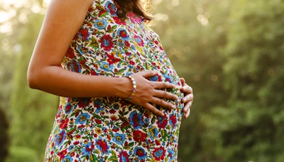 pregnant woman, woman touching pregnant belly, pregnant woman outdoors
