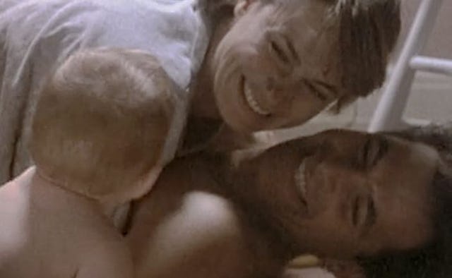 A scene from 'thirtysomething' TV show, a baby looking at a smiling couple