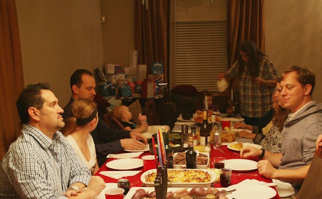 A family gathered for dinner at the grownup table
