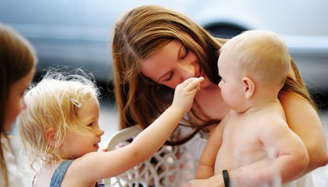 Woman With Two Kids And A Third Baby