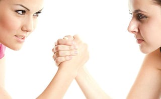 Two girls arm wrestling representing competition from a boyfriend's Ex