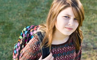 Teen girl posing with a backpack