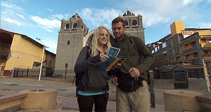 Two "Amazing Race" contesters in front of a castle