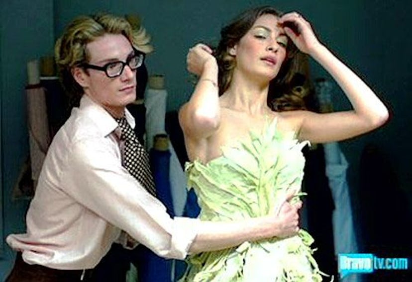 Austin Scarlett adjusting a green dress on a brunette model in "Project Runway"