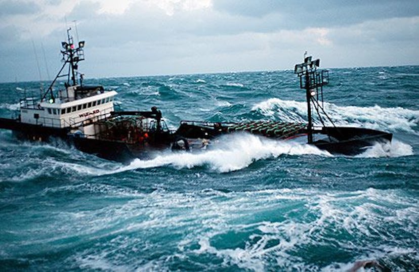 A "Deadliest Catch" fishing boat in the middle of an ocean surrounded by large waves