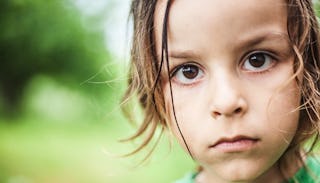 A portrait of a foster child with behavioral problems with a neutral facial expression