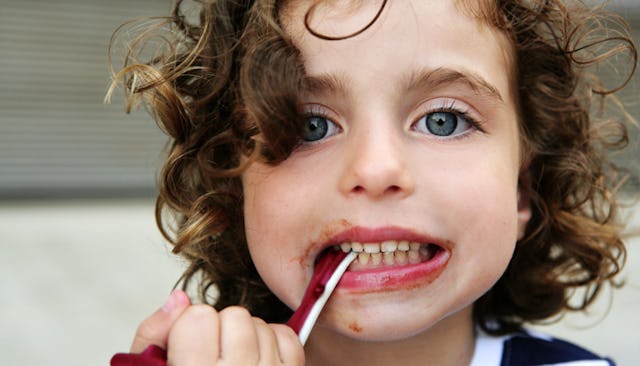 Curly haired boy all messy from eating snacks
