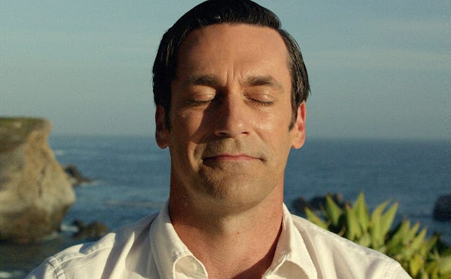 John Hamm as Don Draper enjoying the sun with his eyes closed with the sea in the background 