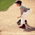 A little boy playing baseball