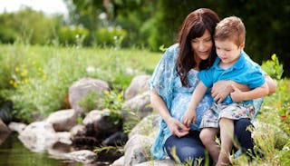 A single mother and her son spending time in the nature 